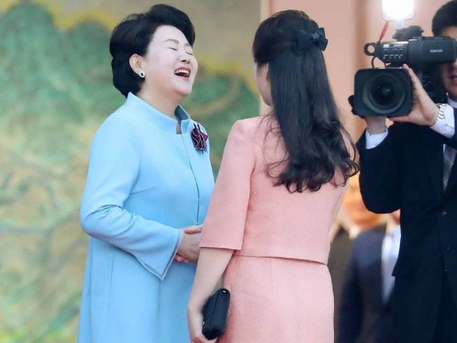 镜头拍下金正淑（左）迎接李雪主大笑画面。